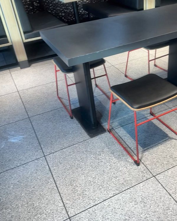 Restaurant tables and seating over a clean floor